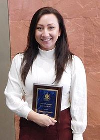 ashley holding her award