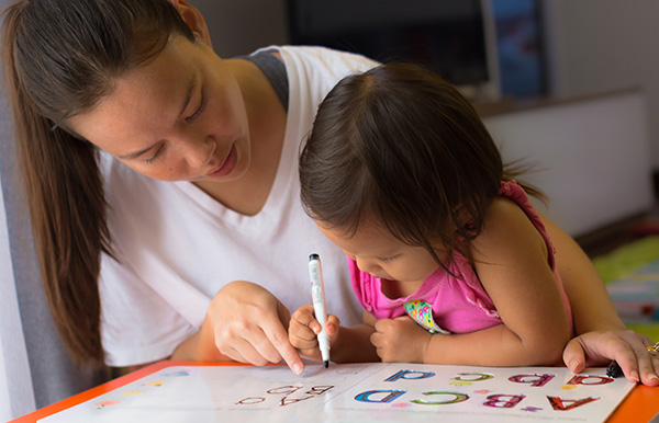 Child learning with a parent